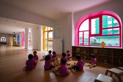 TTC Elite Saigon Kindergarten in by Kientruc O in has a distinctive facade decorated with colourful patches and irregularly shaped windows.
