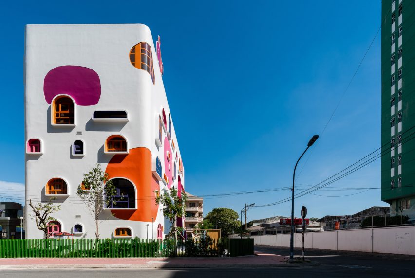TTC Elite Saigon Kindergarten in by Kientruc O in has a distinctive facade decorated with colourful patches and irregularly shaped windows.