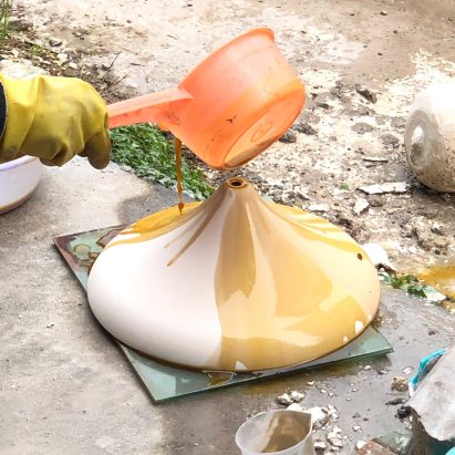The coffee grounds are poured onto the ceramic lamps