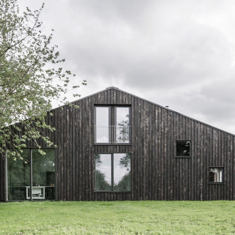 Tractor shed converted into house clad in scorched wood