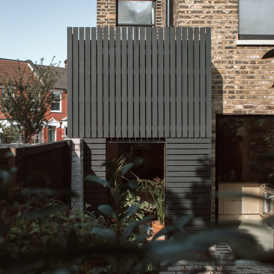 Black-painted larch planks clad extension to a house in London