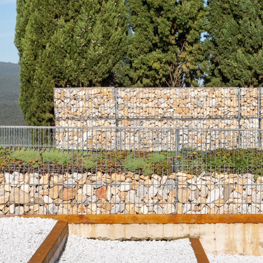 Microscape uses stone-filled cages to update Italian cemetery