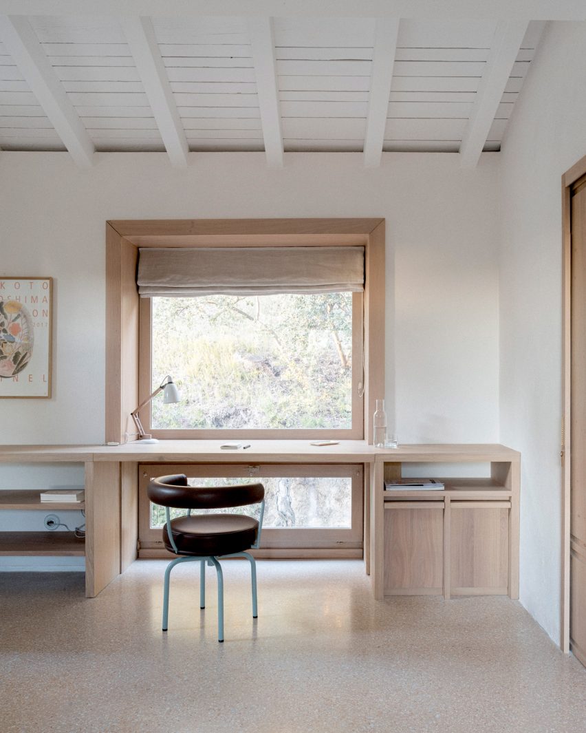 Wooden desk by a timber-framed window in MA House by Timothee Mercier from Studio XM