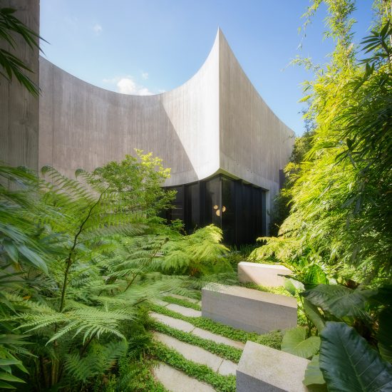 Wood Marsh tops curving concrete walls with zinc disc for house in Melbourne