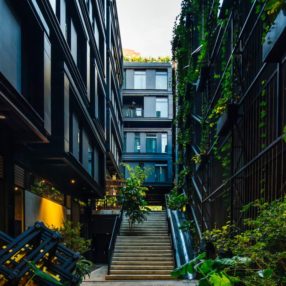 Plants cover grey steel of Hotel Click Clack Medellín by Plan:b Arquitectos