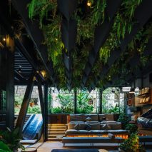 Plants cover grey steel of Hotel Click Clack Medellín by Plan:b Arquitectos