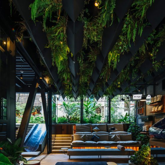 Plants cover grey steel of Hotel Click Clack Medellín by Plan:b Arquitectos