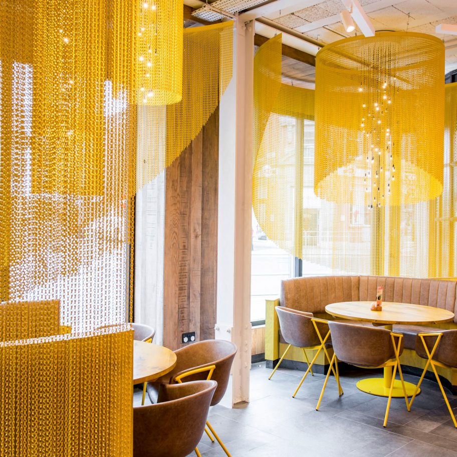 Kriskadecor's chain-link partitions aid social distancing in shared interiors