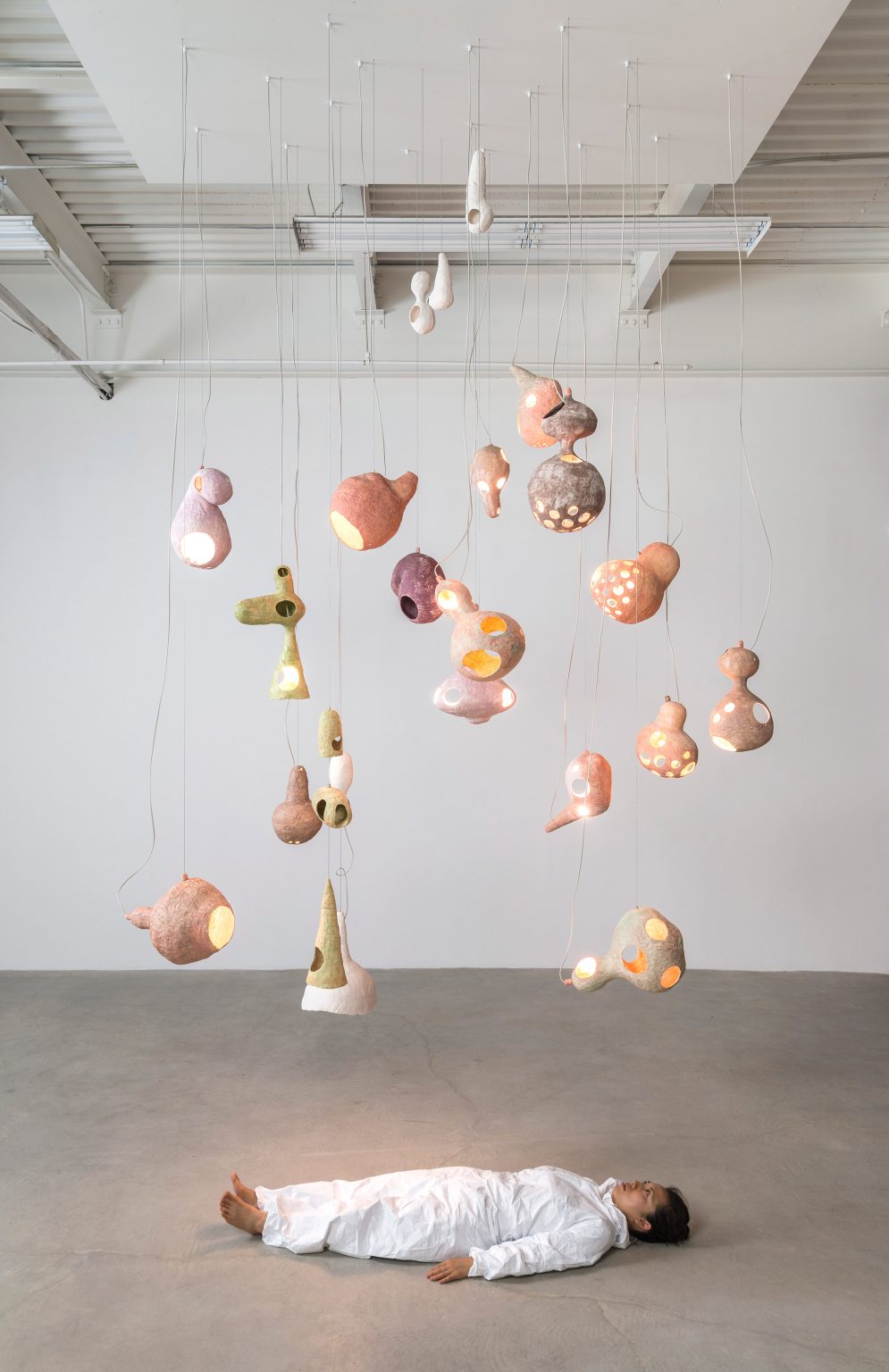 Yuko Nishikawa forms "floating" amorphous lights from shells of clay and paper