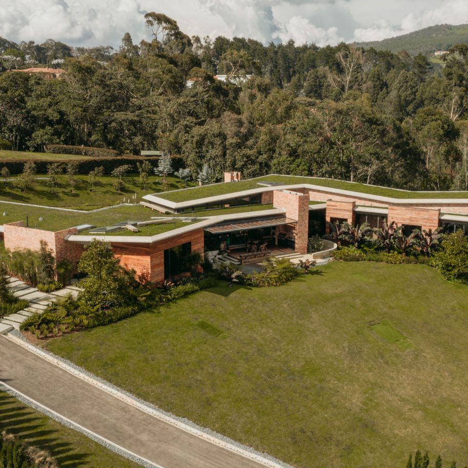 Casa Carmen’s green roofs merge with hill and forest in Colombian neighbourhood