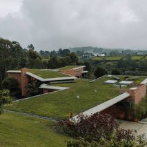 Casa Carmen’s green roofs merge with hill and forest in Colombian neighbourhood