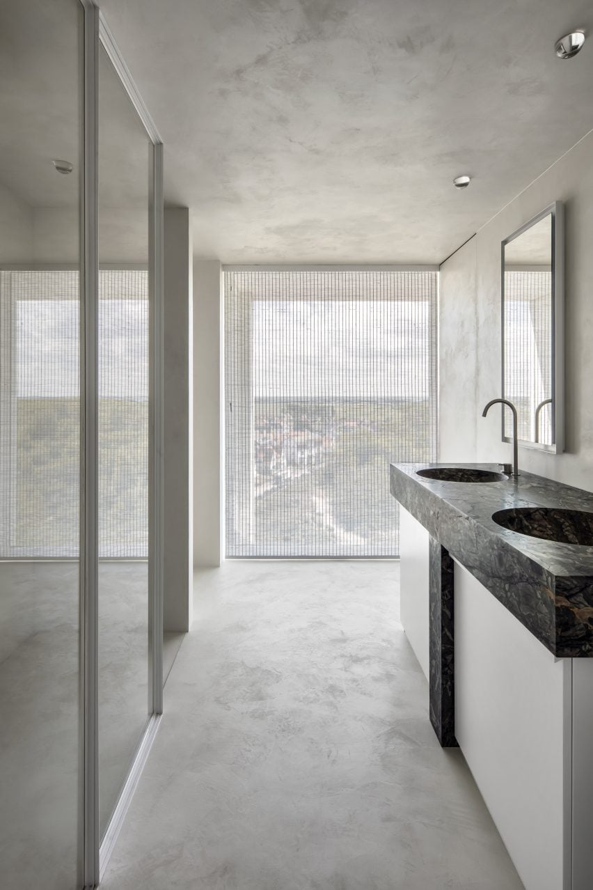 Bathrooms in Belgian apartment feature marble sinks