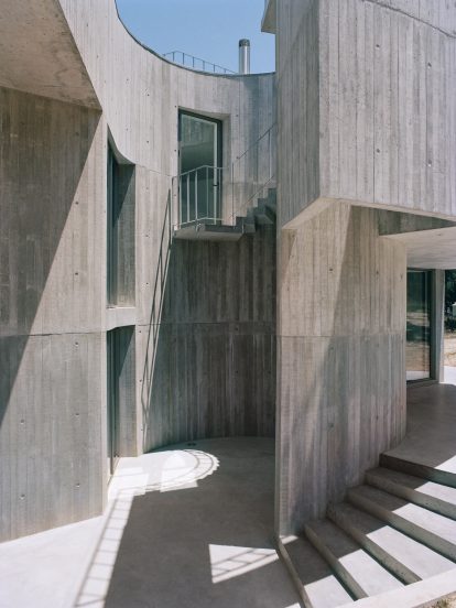 Concrete patio of Trefoil House by Double O Studio
