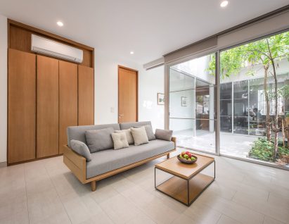 Living room and internal courtyard of the Forest House by Shma Company