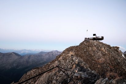 Viewing platform overlooks glacier on top of mountain ridge in South Tyrol