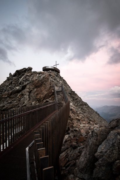 Viewing platform overlooks glacier on top of mountain ridge in South Tyrol
