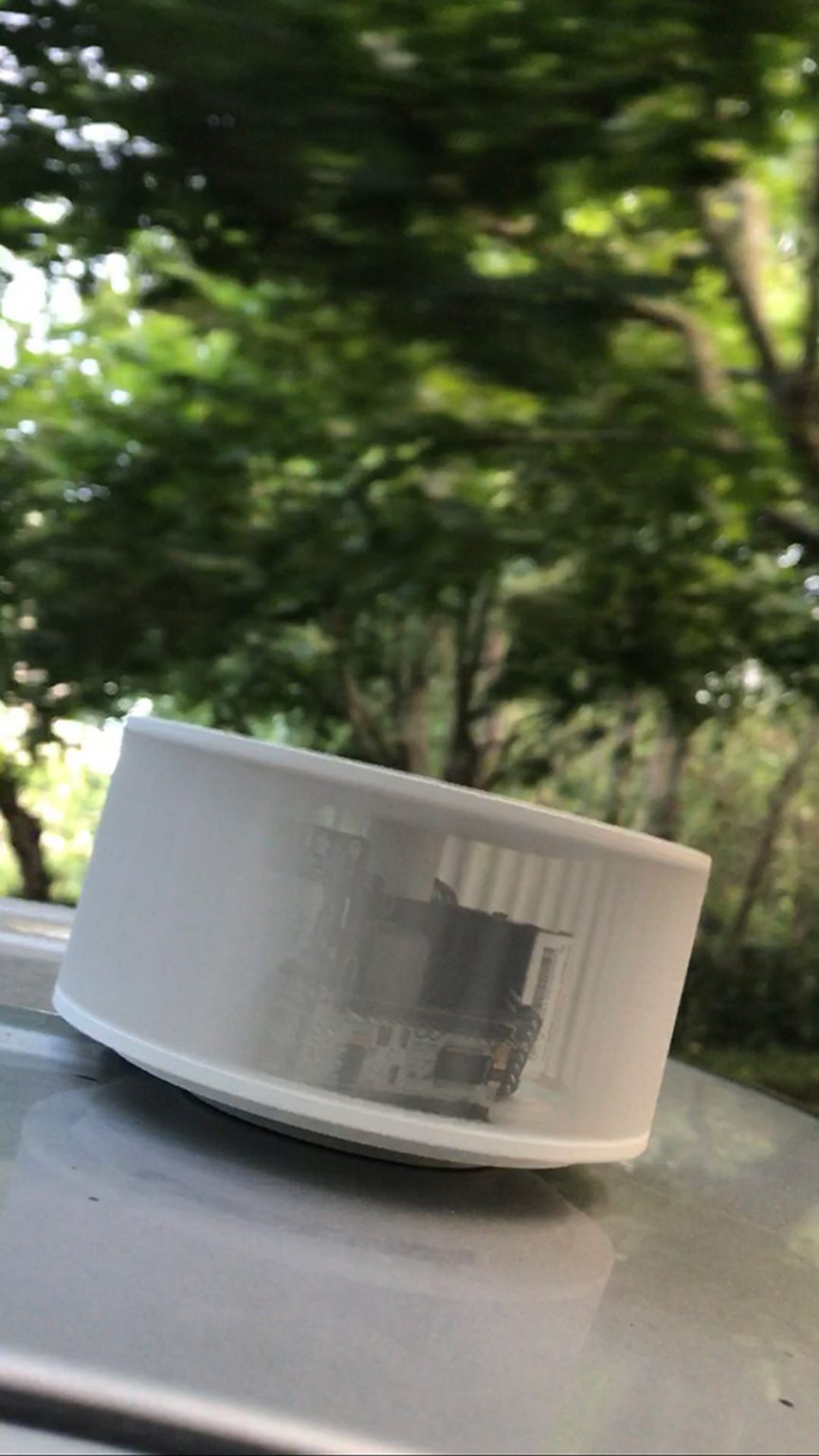 An air quality monitor is fixed to the top of a taxi cab