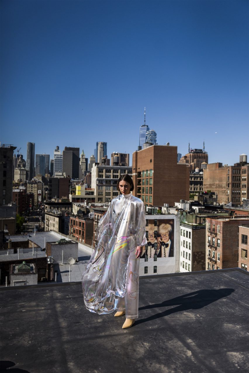 A silver digital dress worn by a female model on a roof