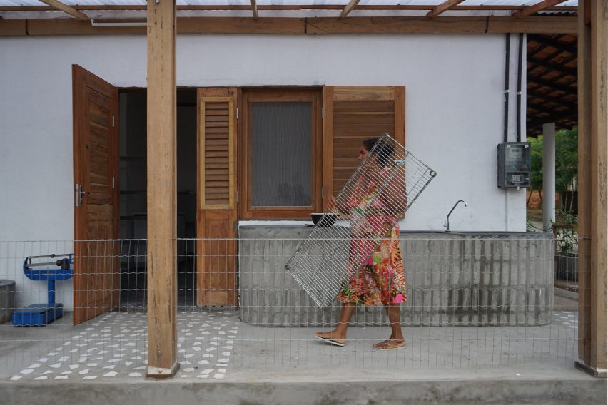 Quebradeira outside Babassu flour factory by Estudio Flume