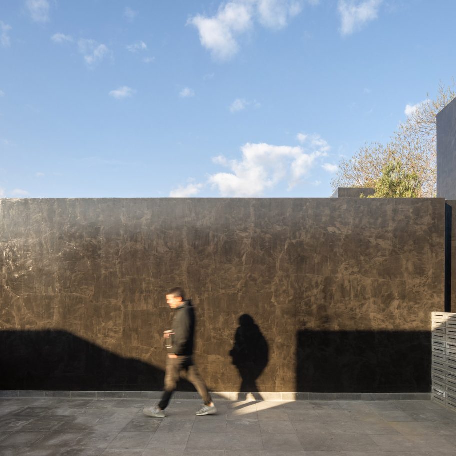 Black monolithic volumes and concrete latticework form Carrizal houses in Mexico City