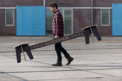The designer carrying Corona Crisis Kruk, a social distancing bench by Object Studio