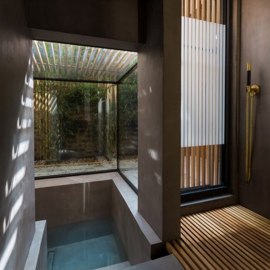 Dark bathroom inside Sunken Bath, UK, by Studio 304