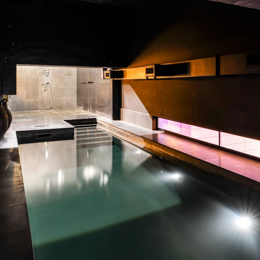 Lost House by David Adjaye features black interiors and bedroom with a pool