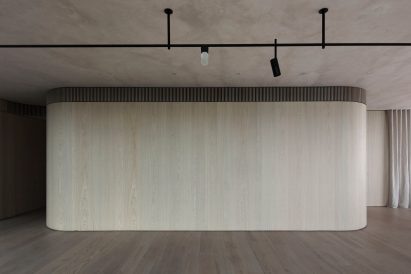 The Melburnian Apartment by Edition Office features oak storage volumes
