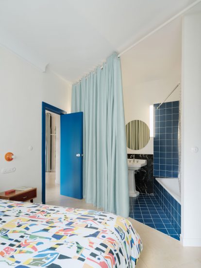 Bathroom split from bedroom by curtain