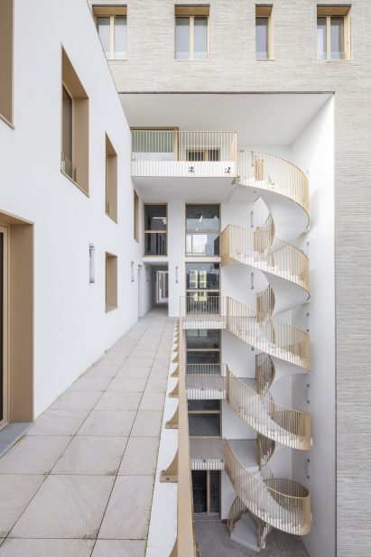 Spiral staircase of Zellige housing in Nantes, France, by Tectône and Tact Architectes