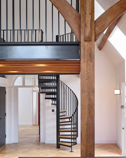 Spiral staircase in Belsize Fire Station apartments by Tate Harmer, London