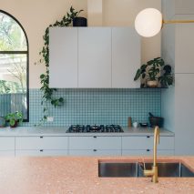 Duck-egg blue kitchen with pink terrazzo breakfast bar