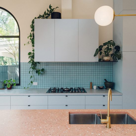 Duck-egg blue kitchen with pink terrazzo breakfast bar