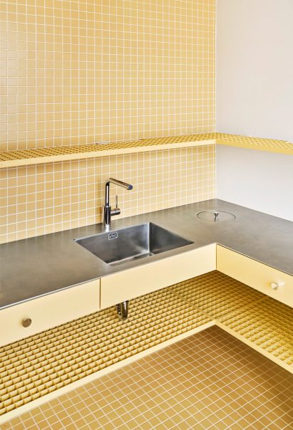Yellow tile and steel counter kitchen