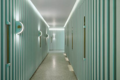 Grooved green walls feature inside Infinity Wellbeing spa in Bangkok