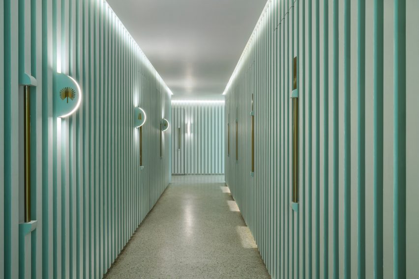 Grooved green walls feature inside Infinity Wellbeing spa in Bangkok