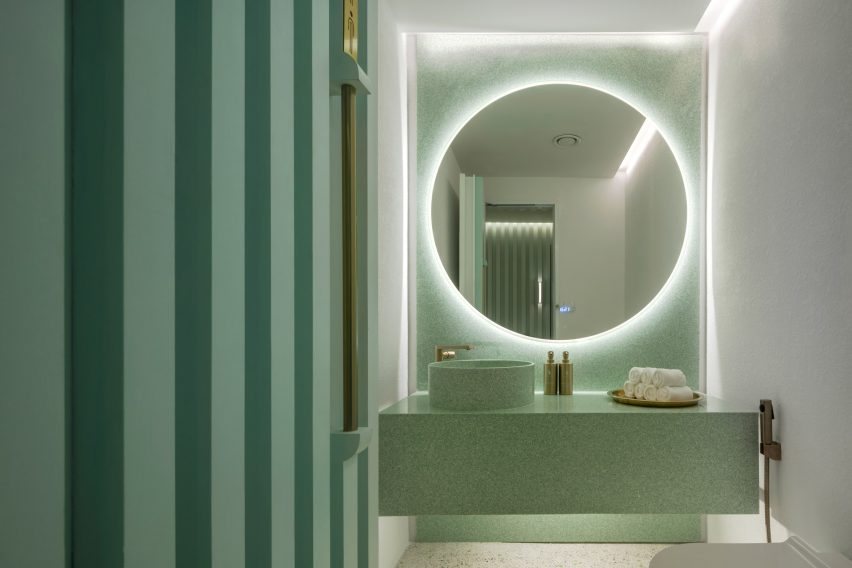 Grooved green walls feature inside Infinity Wellbeing spa in Bangkok