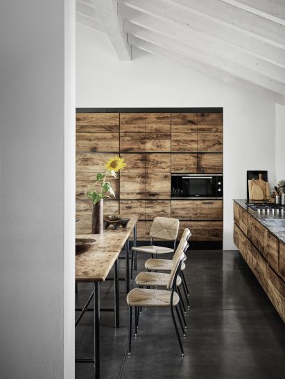 Kitchen and dining room at Country House in the Piacenza Hills by Studio Koster