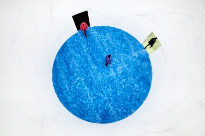 blue fur floor in circular room at Prada show by AMO 