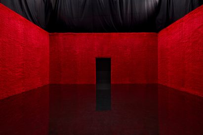 red faux fur clad room at Prada show by AMO 