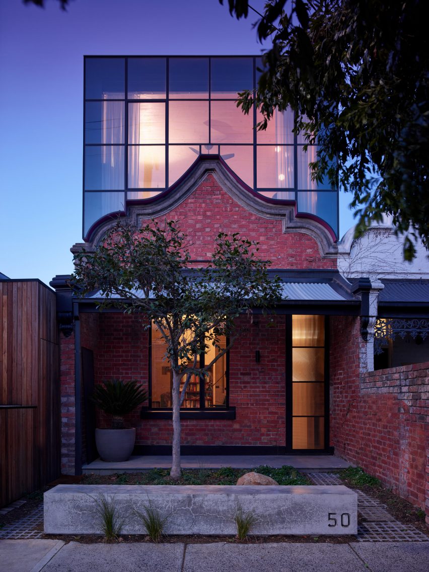 steel and glass box sits atop original facade