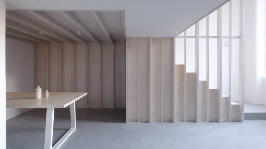 Dining area and wooden staircase from Bow Quarter interior by EBBA Architects