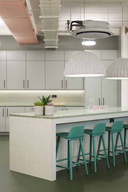 Green stools in office kitchen