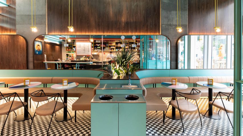 The two banquettes intersected by a planter in Caffettiera Caffé Bar