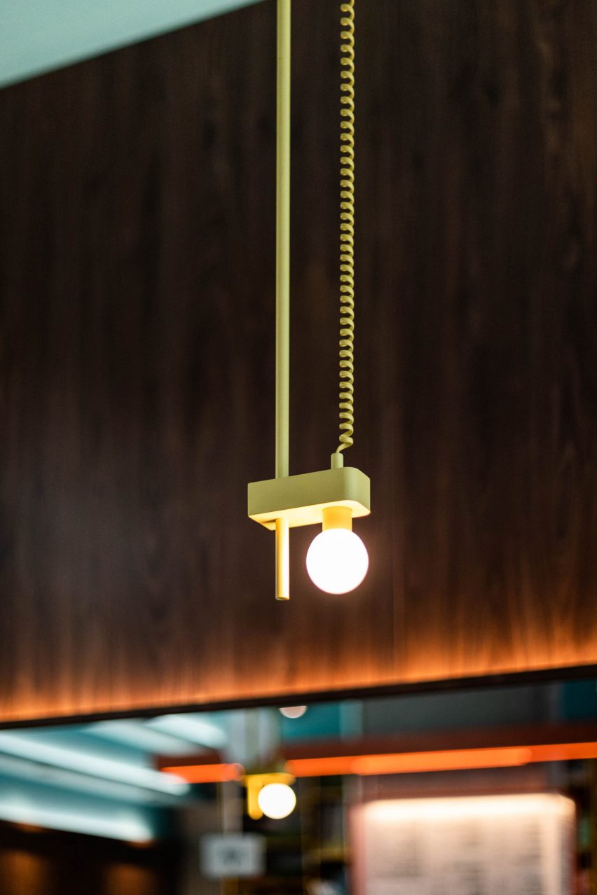 Lambert & Fils pendant lights are suspended from yellow telephone wire above the seating area