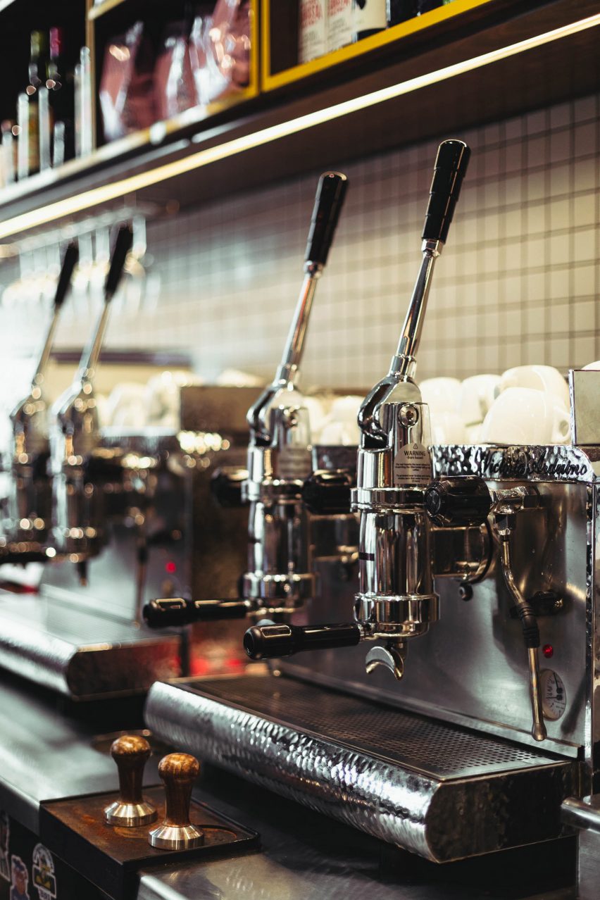 Coffee details behind the main black monolithic terrazzo bar