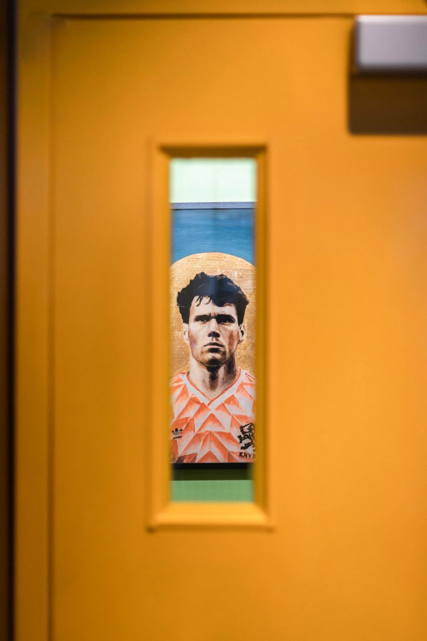 Artwork details from the Caffettiera Caffé Bar bathrooms seen through their yellow doors