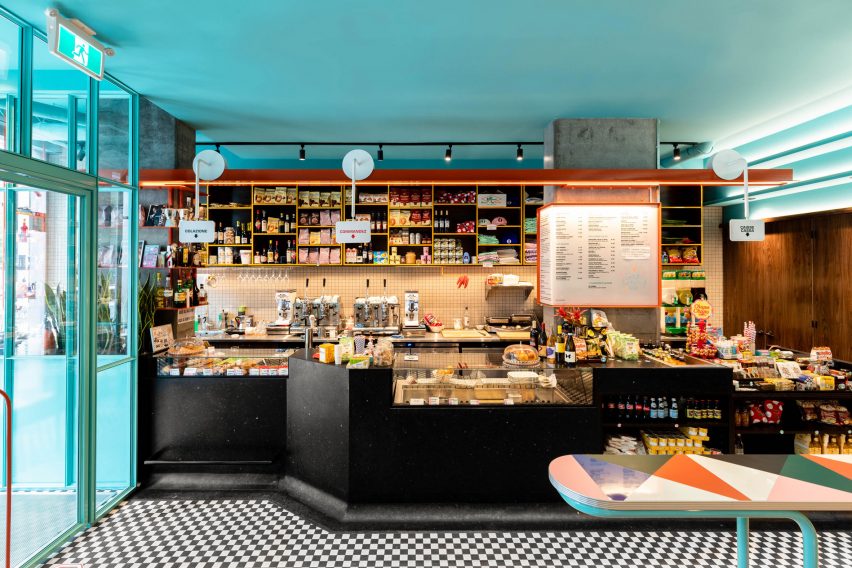 The main black monolithic terrazzo bar showing an orange painted steel beam above the bar