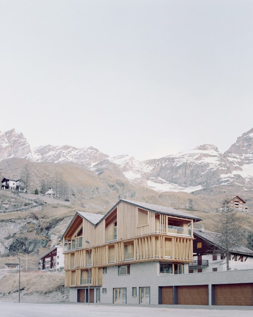 The exterior of a stone and wood-clad chalet by LCA Architetti