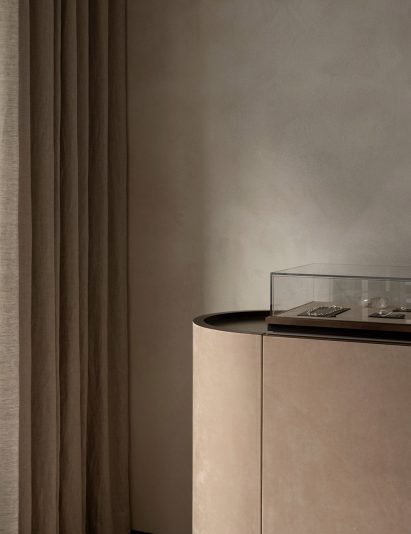 Curtains and suede display case in retail interior by Norm Architects